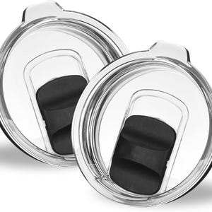 May include: Two clear plastic lids with black rubber seals. The lids are designed to fit on top of a tumbler or cup.