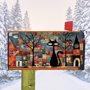 May include: A decorative mailbox featuring a whimsical design with a black cat silhouette. The artwork depicts a colorful village scene with trees and buildings. The mailbox has a red flag and is mounted on a wooden post.