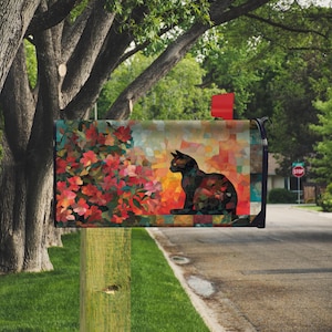 May include: A decorative mailbox featuring a black cat silhouette against a backdrop of colorful flowers and abstract shapes. The design incorporates shades of red, orange, and teal, creating a vibrant and artistic look for outdoor decor.
