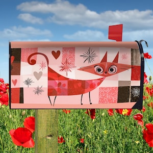 May include: A pink mailbox with a whimsical cat design. The cat is red with a long tail and large eyes, set against a background of hearts, stars, and geometric patterns. The mailbox has a red flag and is mounted on a wooden post.