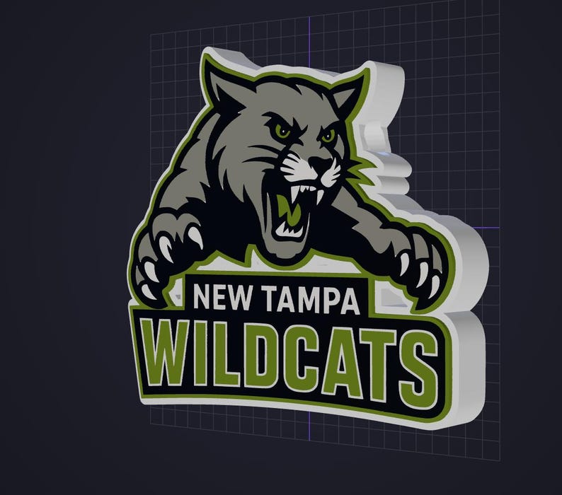 May include: A three-dimensional sign featuring a gray wildcat mascot with green eyes and sharp claws, positioned above the text NEW TAMPA WILDCATS in bold white and green lettering on a black background, with a white border and thick white sides.