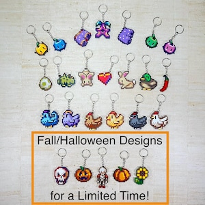 May include: A collection of pixel art keychains featuring various shapes including fruits, animals, and seasonal items. The bottom section is framed in orange with the text Fall/Halloween Designs for a Limited Time! The keychains have metal rings.