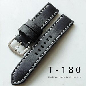 May include: Black leather watch strap with white stitching. The strap features a silver buckle and is labeled "T-180" with the text "BLACK Leather fade watch strap".