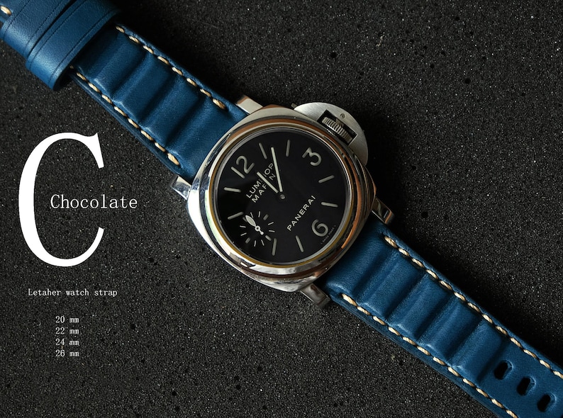 May include: A luxury wristwatch with a black face and silver casing, featuring a blue leather strap with white stitching. The watch face displays the brand name "PANERAI". The image includes the text "Chocolate" and "Letaher watch strap".