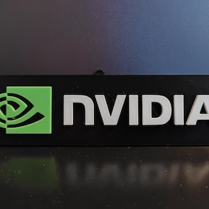 May include: A black rectangular sign with the word "NVIDIA" in white letters and a green logo with a stylized eye shape.