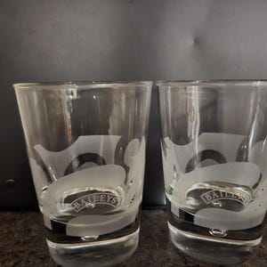 A pair MCM Bailey&#39;s Irish Cream Lowball Glasses with a frosted swirl design  and Controlled Bubble Base