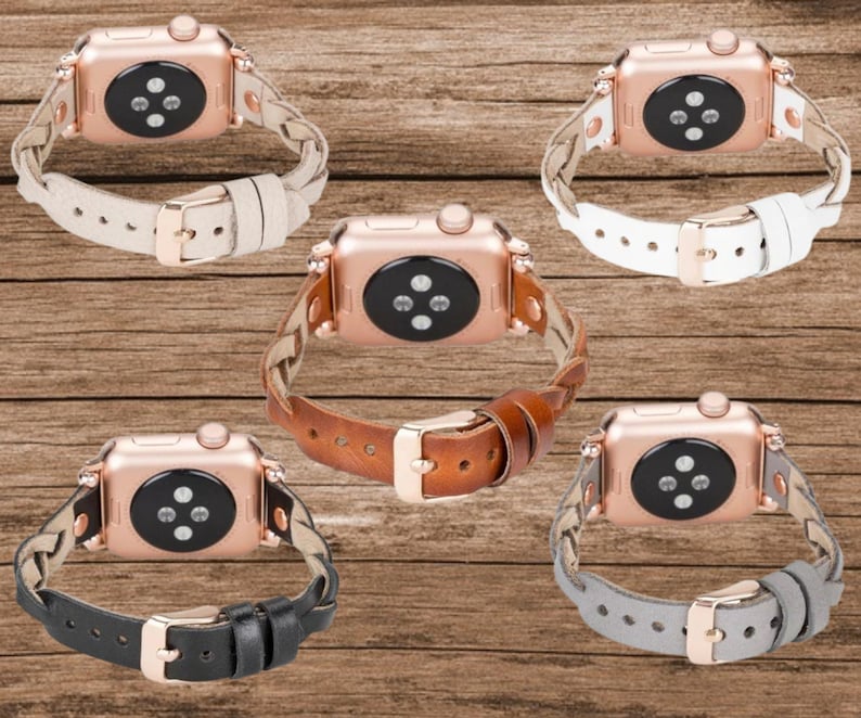 May include: Four different Apple Watch bands in black, brown, white, and gray leather. Each band has a braided design and a rose gold buckle.