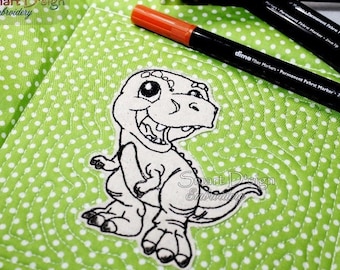 May include: A black and white line drawing of a cartoon dinosaur on a green fabric with white polka dots. The dinosaur is smiling with its mouth open and has a large eye. The fabric has the text "Smart Design Embroidery" printed on it.