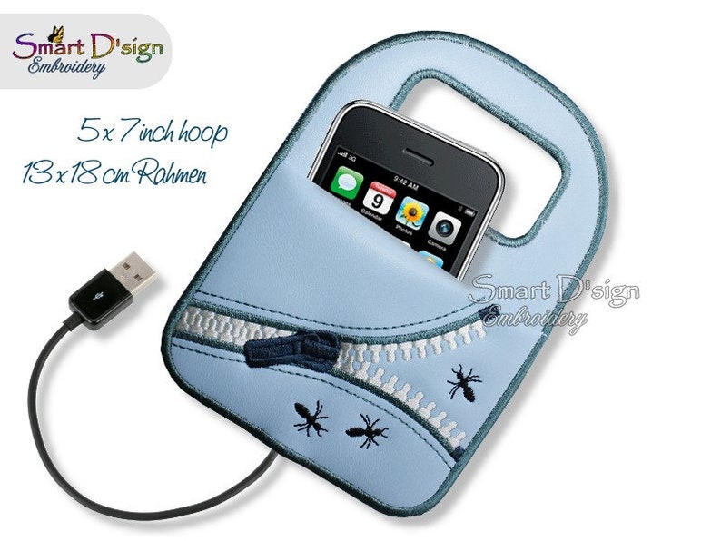 May include: A light blue phone case with a zipper detail and embroidered ants. The case has a handle and a pocket for a phone. A black USB cable is attached to the case. The text "Smart D'sign Embroidery" is visible on the case.