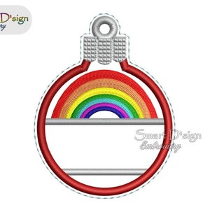 May include: A red and white Christmas ornament with a rainbow design and a blank space for personalization. The ornament has a silver loop at the top.