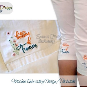 Puede incluir: Diseño de bordado a máquina para el bajo de los pantalones. El diseño incluye el texto "bajo de los pantalones" con un diseño floral.