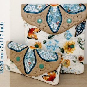 May include: Two fabric pouches with floral patterns and butterfly designs. The larger pouch is 18x30 cm / 7x11.7 inches and the smaller pouch is 18x30 cm / 7x11.7 inches. Both pouches have a brown leather flap with a flower design and green buttons.