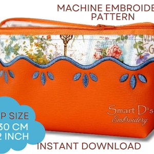 May include: Orange zippered pouch with a floral design and blue embroidery. The pouch is 18 cm by 30 cm and is for machine embroidery.