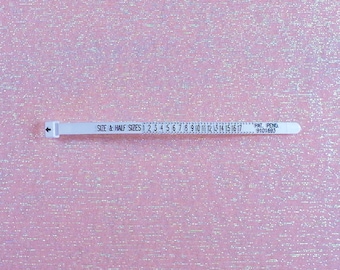 May include: White plastic measuring tape with black markings for size and half sizes from 1 to 17. The text "SIZE & HALF SIZES" and "PAT. PENG 9101693" is printed on the tape.