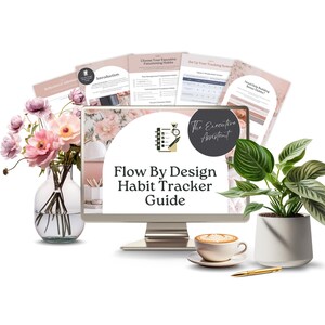May include: A computer monitor displays the "Flow By Design Habit Tracker Guide" with accompanying documents. The scene includes a coffee cup, a pen, a potted plant, and a vase of pink flowers, creating a workspace aesthetic.