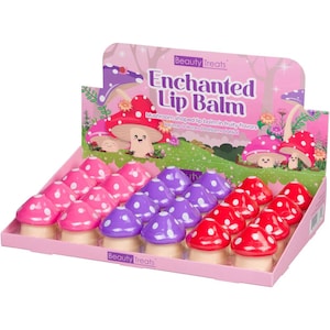 May include: A display of mushroom-shaped lip balms in pink, purple, and red with white polka dots. The packaging reads "Enchanted Lip Balm" and "Beauty Treats". The lip balms are arranged in a pink display case.