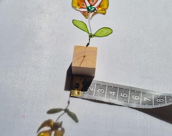 Colourful painted resin flower on mini wooden block. (Yellow.) 9 cms approx height. Very pretty unusual gift for any occasion.