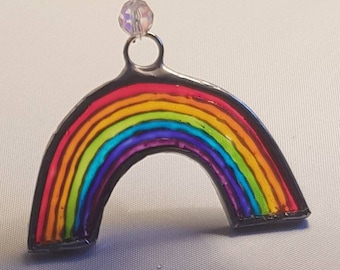 Small (8.0 x 4.5cms) painted glass rainbow. Reflects coloured light and lifts the spirits. Lovely gift - birthday or anytime.