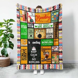 May include: A colorful bowling-themed blanket with various rectangular panels. Each panel features bowling-related graphics and text, including phrases like "I Love Bowling," "Bowling Zone," and "Keep Calm and Go Bowling." The blanket has a patchwork design.