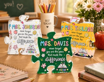 May include: Three acrylic puzzle piece plaques featuring personalized teacher names, floral graphics, and the text: never forget you are the piece that made the difference. Each plaque includes a small open book icon and the name Olivia at the bottom.