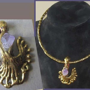 May include: A gold-toned necklace and pendant set. The necklace has a textured, hammered appearance. The pendant features a gold-toned abstract design with a light purple crystal. The pendant is displayed on a black mannequin head.