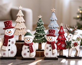 May include: A collection of wooden holiday figurines including two snowmen wearing red hats and scarves, a reindeer with a green bow, and four stylized Christmas trees in natural wood, green, blue, and red colors, all featuring snowflake patterns.