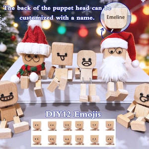 May include: Wooden puppet figures with interchangeable emoji faces. One figure wears a Santa hat and beard. The text "DIY12 Emojis" is displayed. The back of the puppet head can be customized with a name.