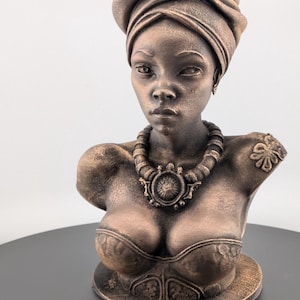 Bronze-toned African sculpture bust of a regal Black woman in a layered headwrap with beaded necklace; decorative home decor for mantel or living room.