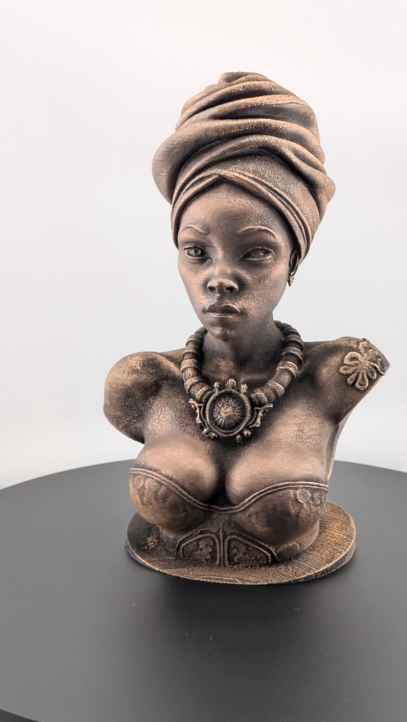 Bronze-toned African sculpture bust of a regal Black woman in a layered headwrap with beaded necklace; decorative home decor for mantel or living room.