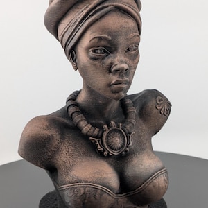 Bronze-toned African sculpture bust of a regal Black woman in a layered headwrap with beaded necklace; decorative home decor for mantel or living room.