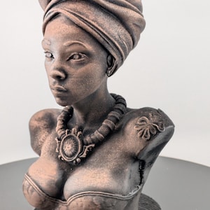 Bronze-toned African sculpture bust of a regal Black woman in a layered headwrap with beaded necklace; decorative home decor for mantel or living room.