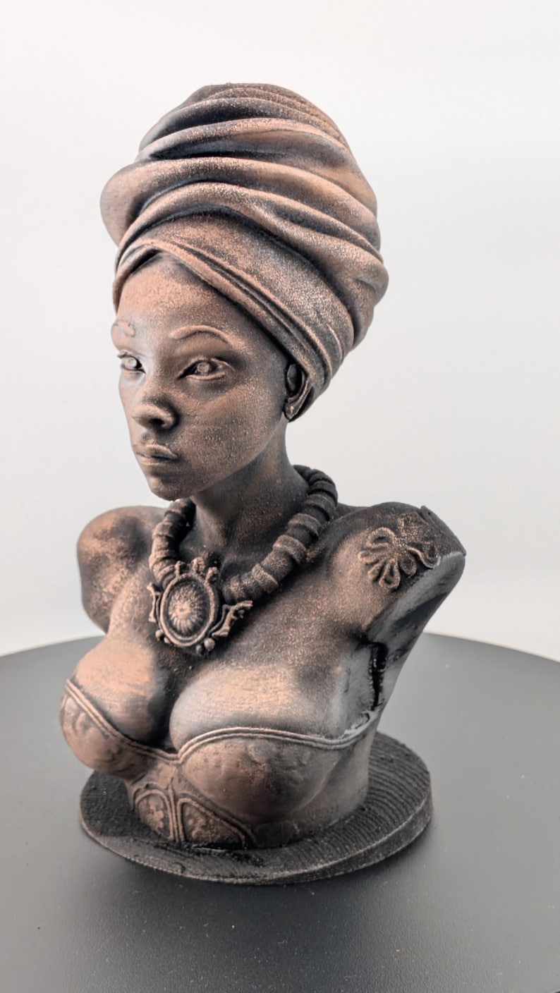 Bronze-toned African sculpture bust of a regal Black woman in a layered headwrap with beaded necklace; decorative home decor for mantel or living room.