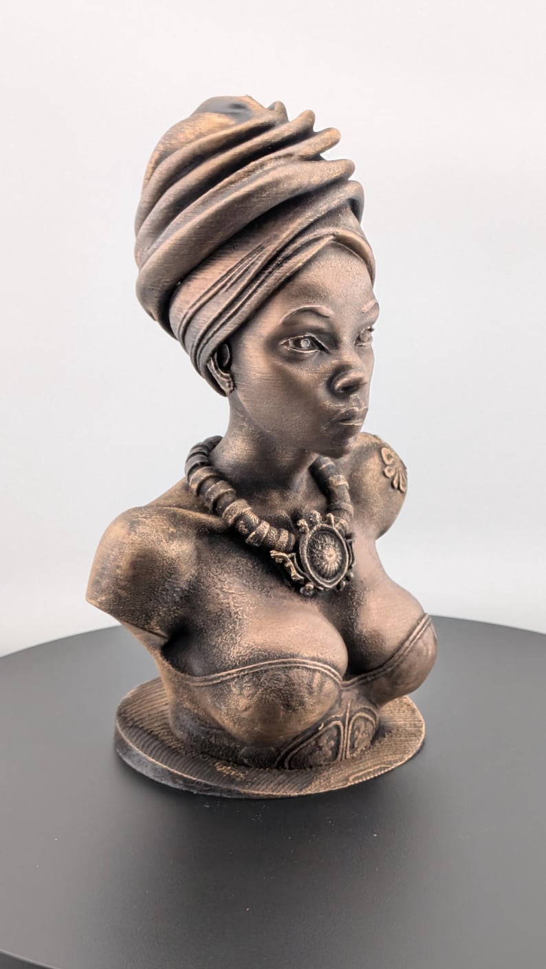 Bronze-toned African sculpture bust of a regal Black woman in a layered headwrap with beaded necklace; decorative home decor for mantel or living room.