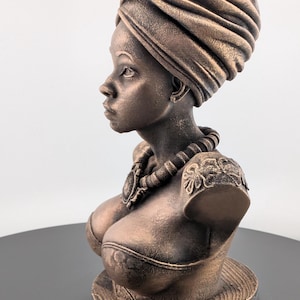 Bronze-toned African sculpture bust of a regal Black woman in a layered headwrap with beaded necklace; decorative home decor for mantel or living room.