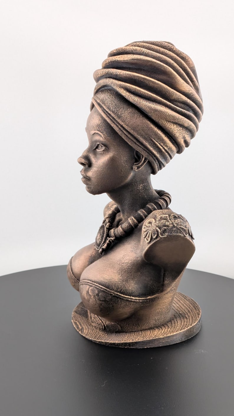 Bronze-toned African sculpture bust of a regal Black woman in a layered headwrap with beaded necklace; decorative home decor for mantel or living room.
