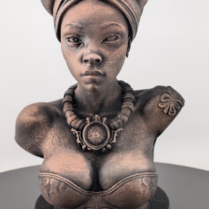 Bronze-toned African sculpture bust of a regal Black woman in a layered headwrap with beaded necklace; decorative home decor for mantel or living room.