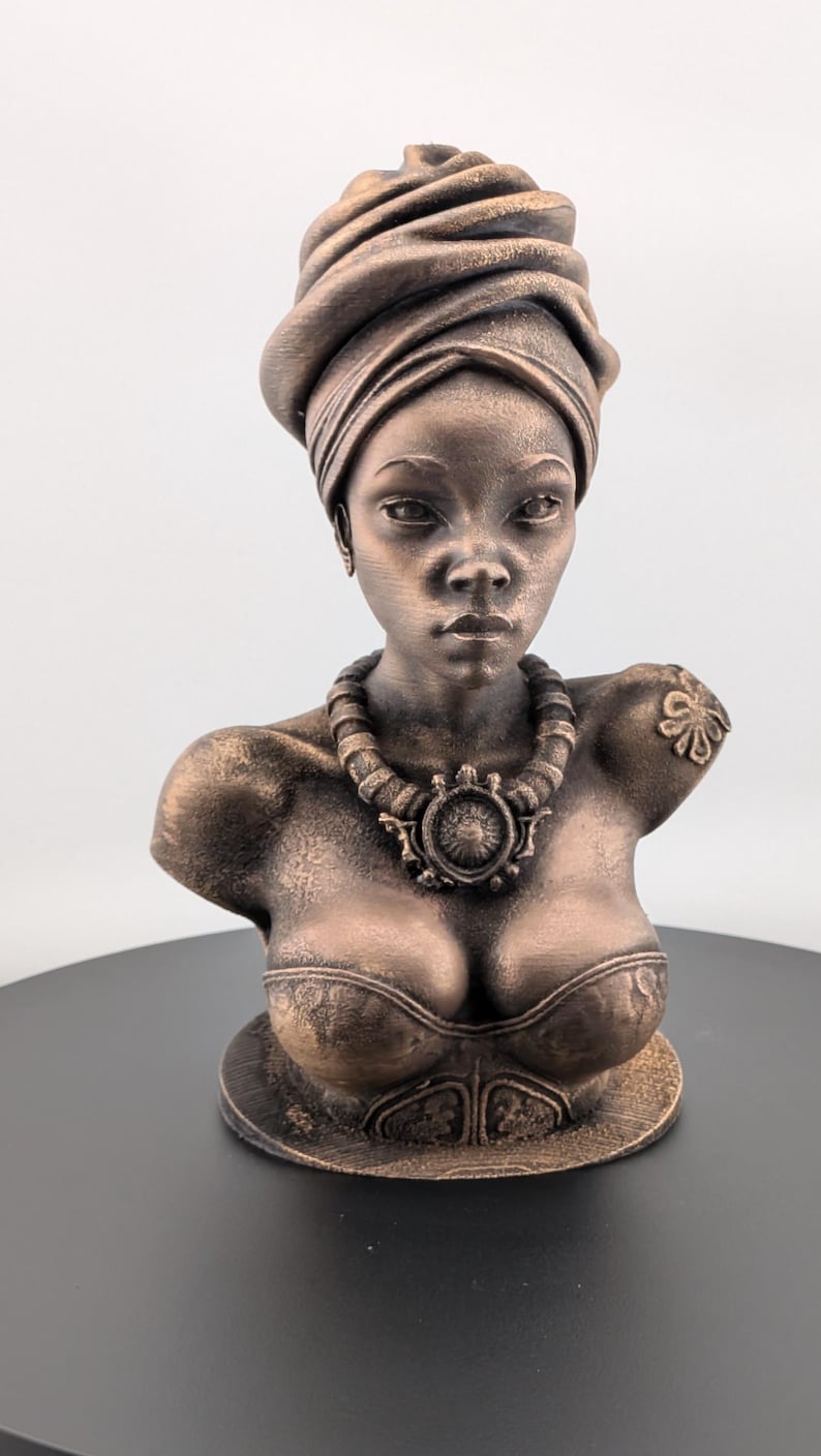 Bronze-toned African sculpture bust of a regal Black woman in a layered headwrap with beaded necklace; decorative home decor for mantel or living room.