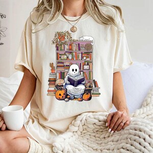 a woman sitting on a bed holding a cup of coffee