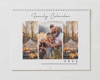 May include: A family calendar with a photo of a family of four in a fall setting. The photo shows a couple with two young children, all smiling. The calendar is titled "Family Calendar" and the year "2025" is printed below the photo.