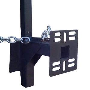 May include: A black metal bracket with a square opening and two sets of parallel lines. A chain is attached to the bracket. The bracket has a vertical support and a horizontal arm.