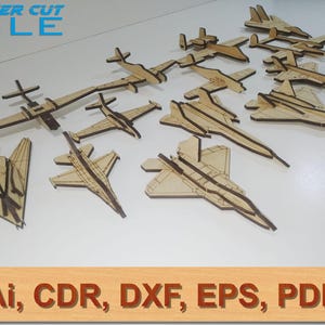 May include: A collection of laser cut wooden airplane models. The models are in various sizes and styles, and are arranged on a white surface. The text "LASER CUT FILE" is visible in the top left corner of the image. The text "Ai, CDR, DXF, EPS, PDF" is visible in the bottom of the image.