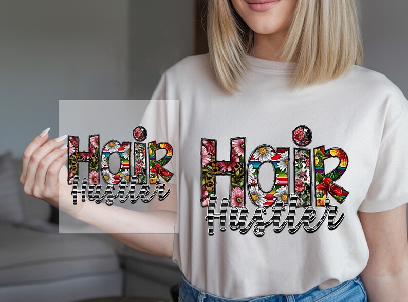 May include: A white t-shirt with a floral design that says "Hair Hustler".