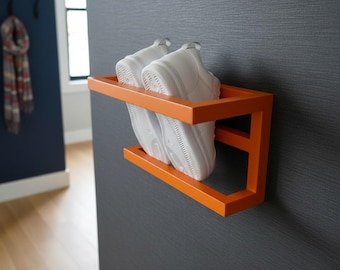 Estantería de pared flotante de metal naranja con forma de zapatilla