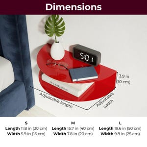 May include: A red, semi-circular wall shelf with dimensions labeled. The shelf holds a small white vase with a green plant, glasses, a digital clock displaying 5:01, and books. Sizes are S: 11.8 in (30 cm) long, M: 15.7 in (40 cm) long, and L: 19.6 in (50 cm) long.