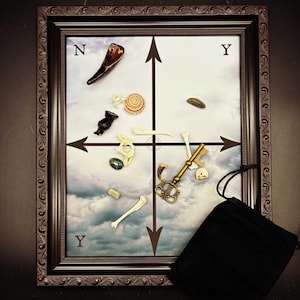 May include: A framed artwork featuring a cloudy sky background with various objects arranged in a grid pattern. The objects include bones, a key, a snail shell, and a black pouch. The frame is dark brown with ornate detailing.