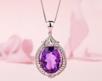 May include: A silver pendant necklace with a large oval amethyst gemstone surrounded by smaller diamonds. The pendant is set in a delicate, ornate design.