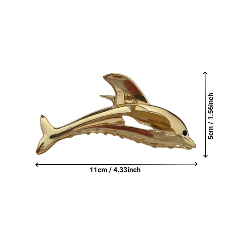 Puede incluir: Una pinza para el pelo de color dorado en forma de delf&iacute;n, que mide 11 cm de largo y 4 cm de alto.