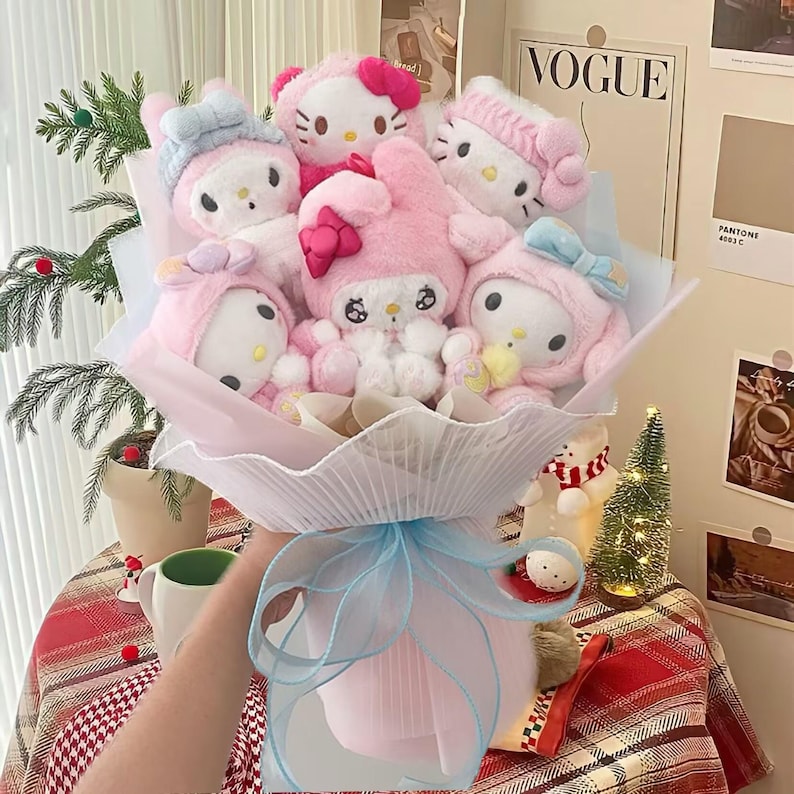 May include: A pink and white bouquet of plush toys featuring popular cartoon characters. The bouquet is wrapped in pink and white tissue paper and tied with a blue ribbon.