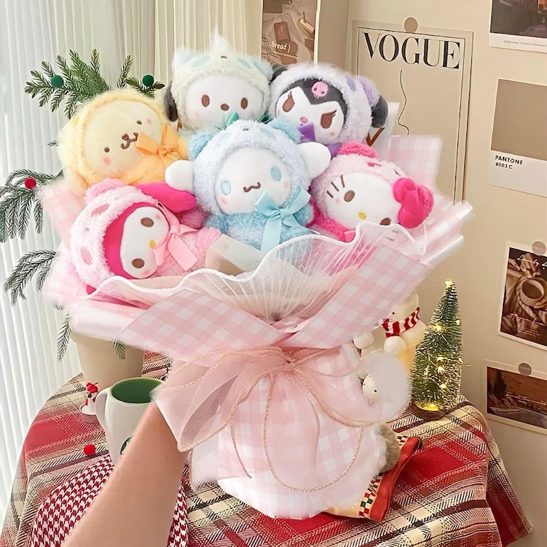 May include: A pink and white gingham bouquet with a pink ribbon and a variety of plush toys. The toys include a yellow and white bunny, a blue and white bear, a pink and white cat, a pink and white penguin, and a pink and white unicorn.
