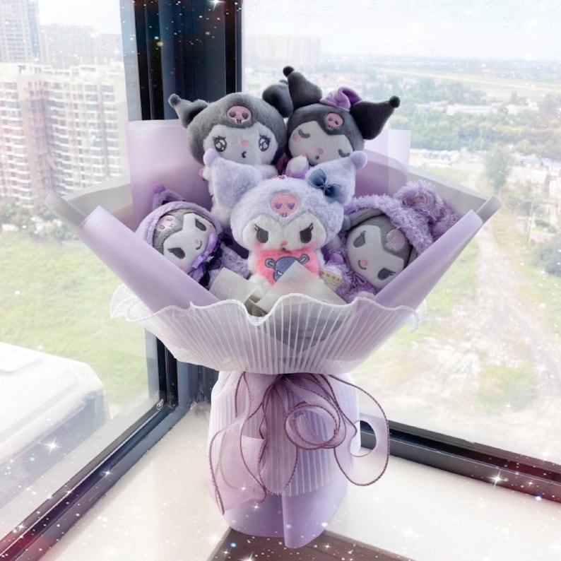 May include: A bouquet of plush toys wrapped in purple and white paper. The toys are all different characters with black eyes and pink cheeks. The bouquet is tied with a purple ribbon.